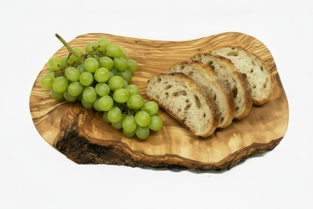 Wooden cutting board with a natural, wavy edge on a white background