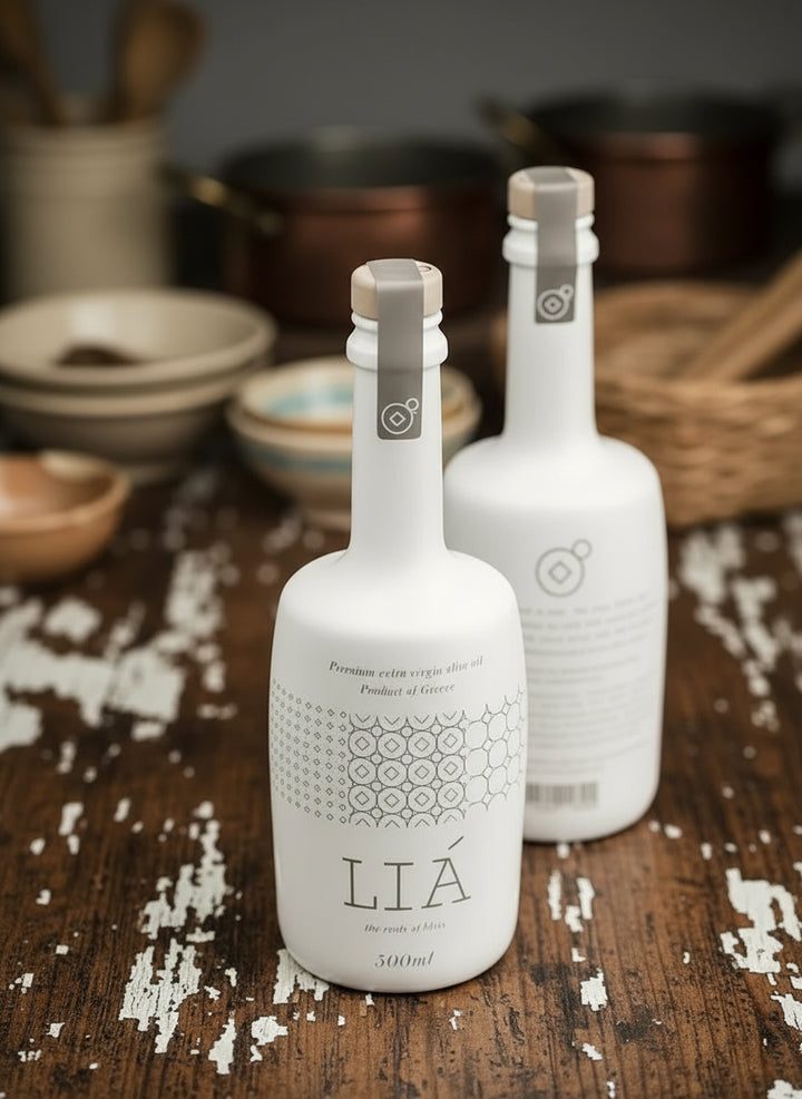 Two white bottles with 'LIÓ' branding on a wooden surface